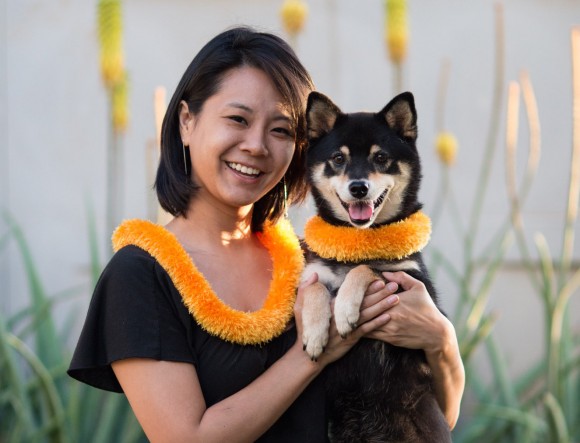 Hawai`i Doggie Bakery co-owner Niki poses in her matching lei with Official HDB Taste Tester Katsumi Firefox
